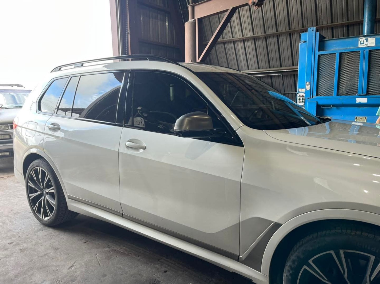 White SUV tint job inside shop